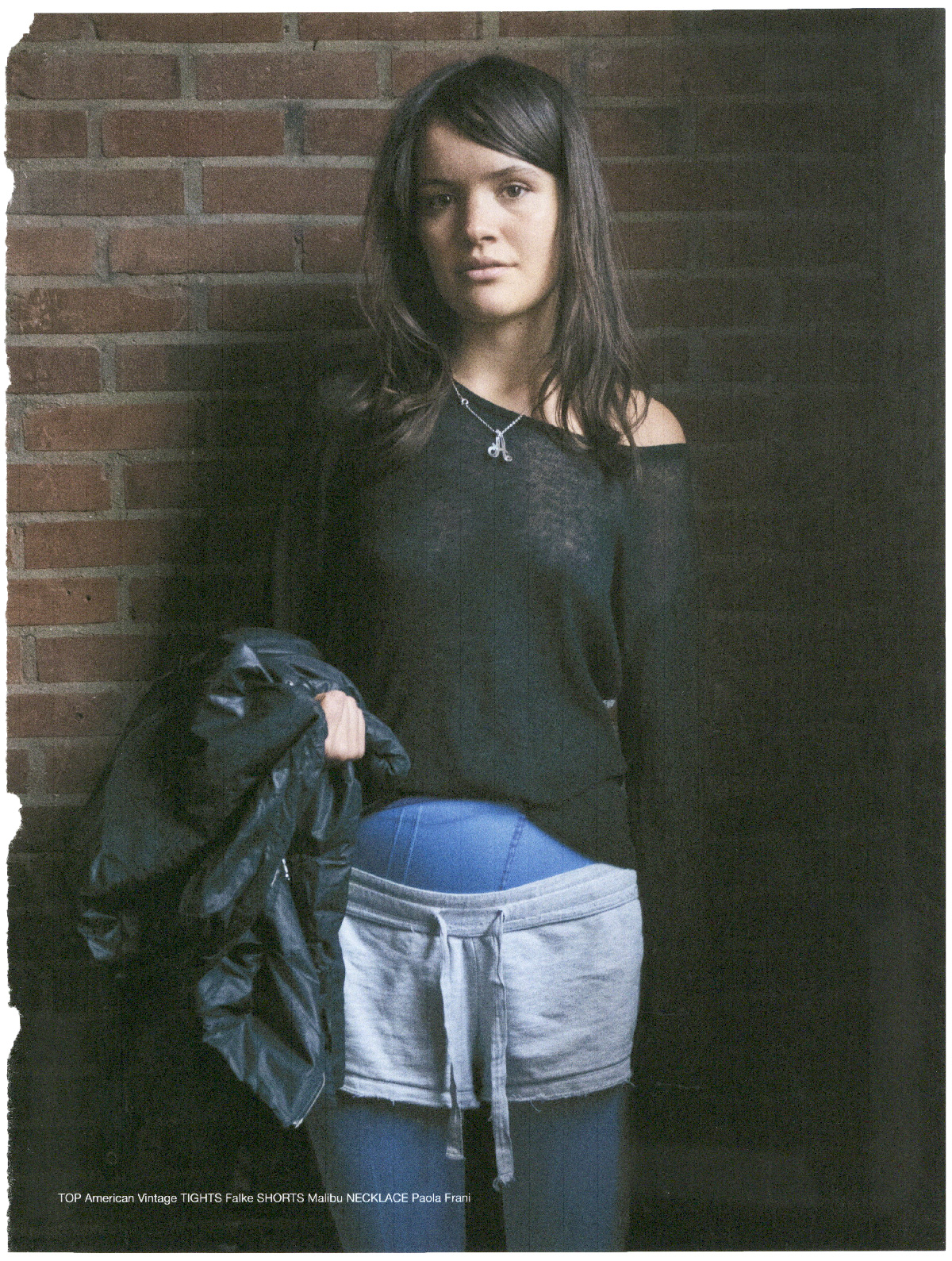 Woman posing against a brick wall, fashion editorial, Concerning Magazine, Alva Issue