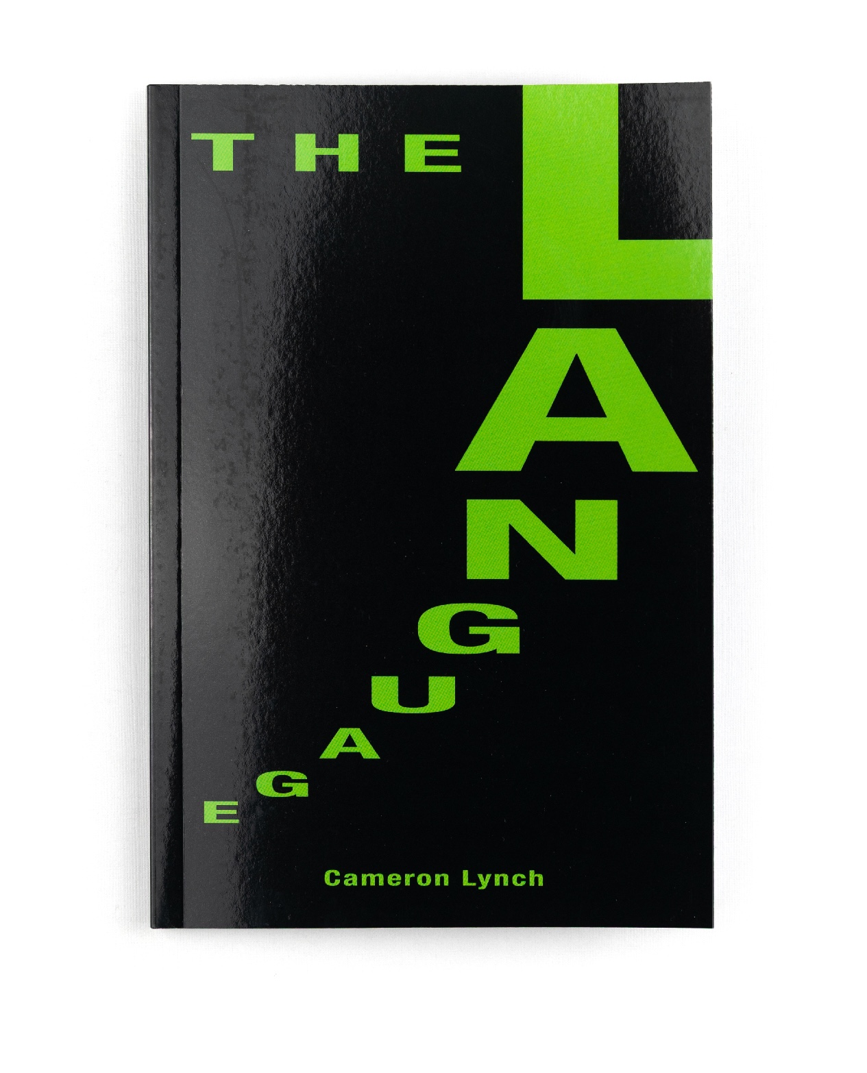 Front cover of The Language by Cameron Lynch with large stepped green letters on black, book design